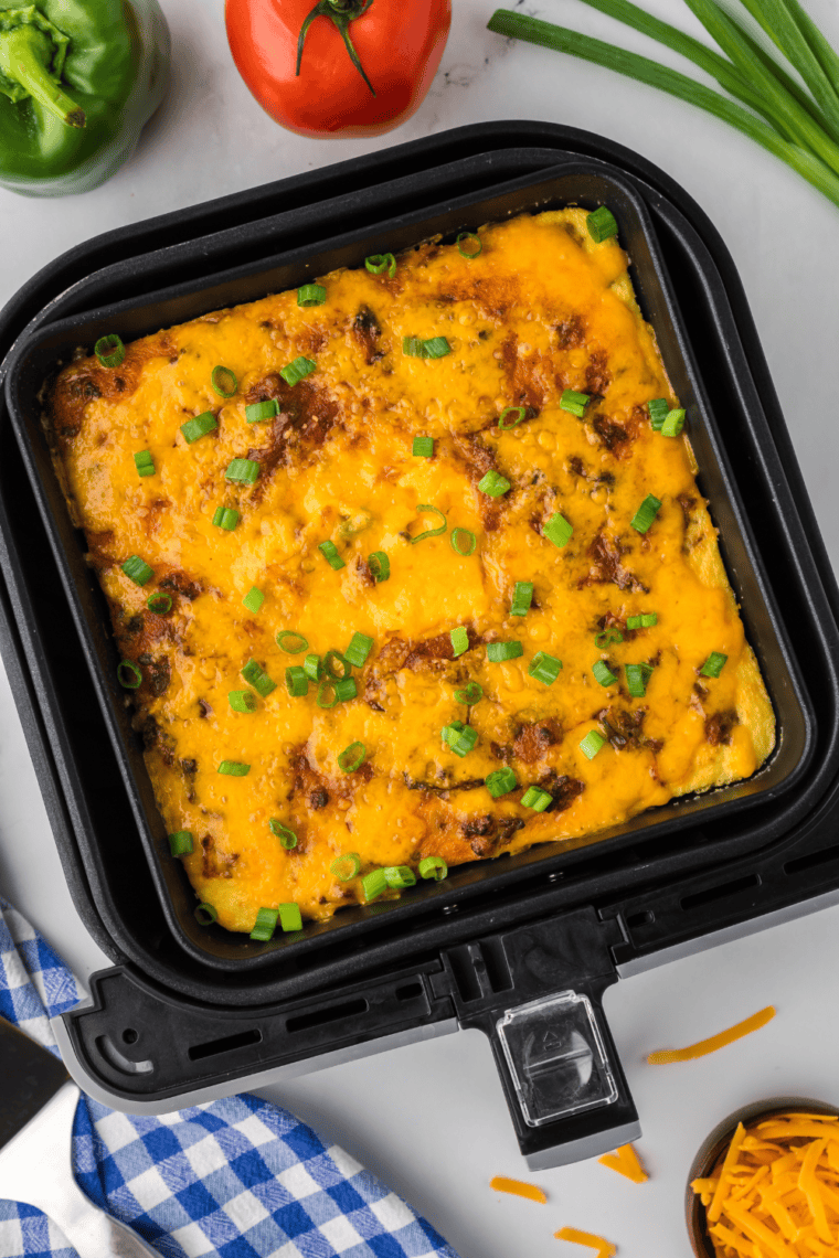 Air Fryer Ground Beef Casserole with seasoned ground beef, creamy eggs, and melted cheese on top.