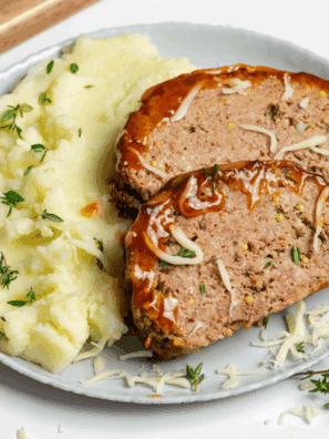Air Fryer Guinness Cheddar Meatloaf with melted cheese and Guinness-infused flavor.