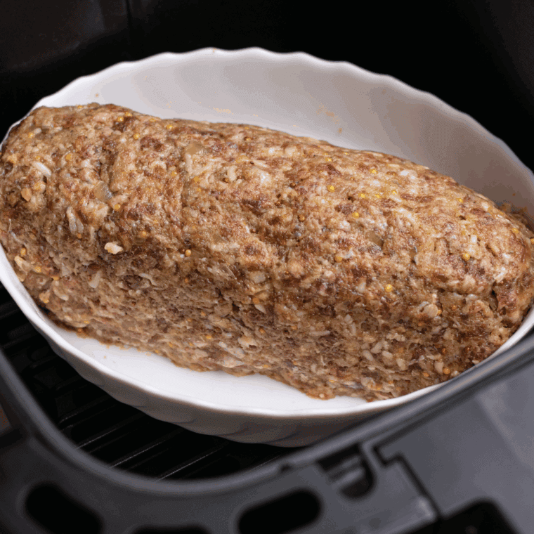 Forming meatloaf into a loaf shape, cooking at 375°F, and adding topping midway through.