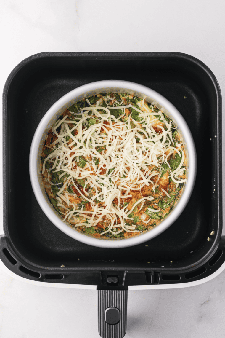 Spread the mozzarella cheese over the top of the frittata.