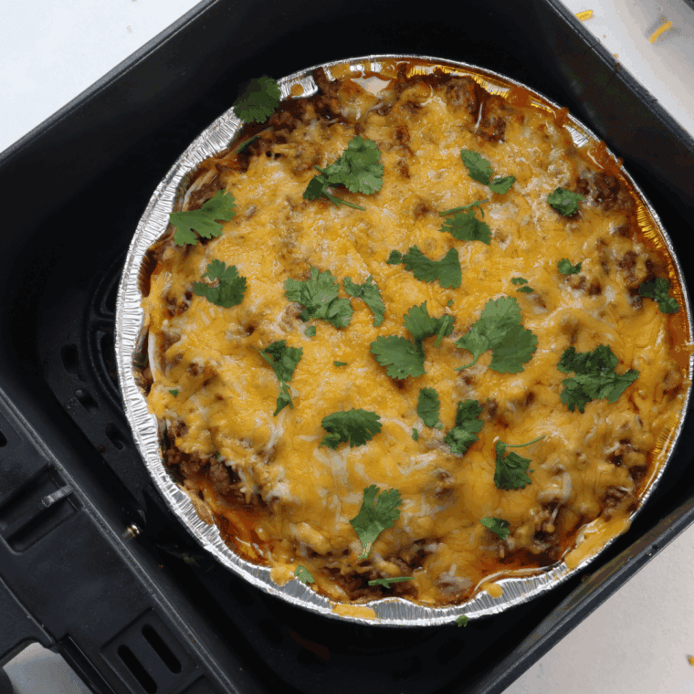 Cooking the layered Mexican lasagna in the air fryer until golden and bubbly.