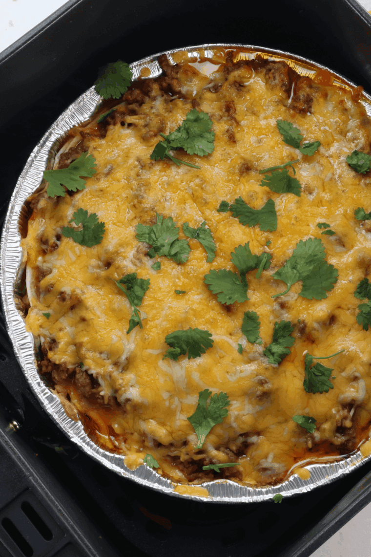 Golden, cheesy Air Fryer Mexican Lasagna fresh out of the air fryer, topped with optional jalapeños and garnished with cilantro.