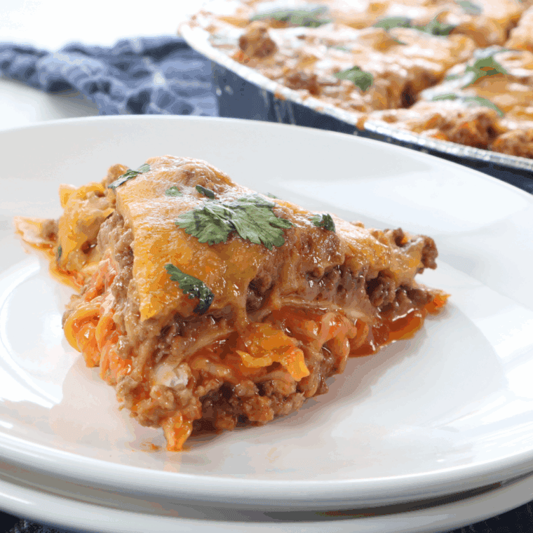Air Fryer Mexican Lasagna with beef, tortillas, cheese, and enchilada sauce.