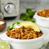 Air fryer Mexican rice casserole with seasoned rice, chicken, and melted cheese.