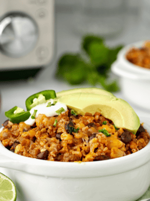 Air fryer Mexican rice casserole with seasoned rice, chicken, and melted cheese.