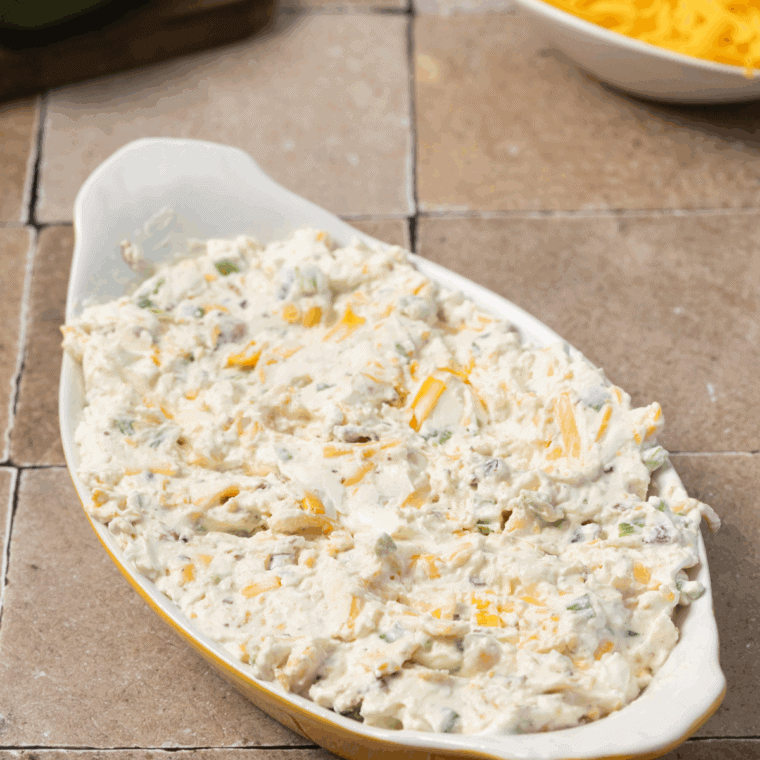 Placing the dip into an oven-safe dish, ready for air frying.