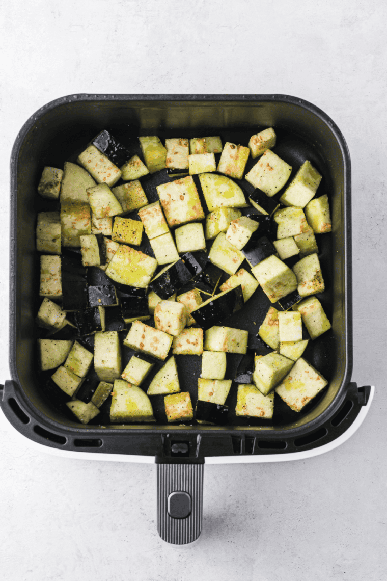 Cooking eggplant at 375°F (190°C) for 12-15 minutes, shaking the basket halfway through, until golden and tender.