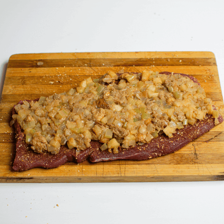 Patting pork tenderloin dry with paper towels, rubbing with olive oil, and seasoning with garlic powder, onion powder, paprika, salt, and pepper.