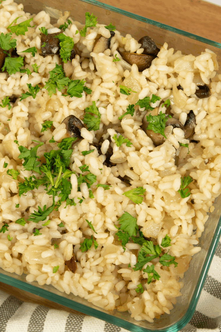 Bowl of creamy risotto garnished with parsley, made in the air fryer.