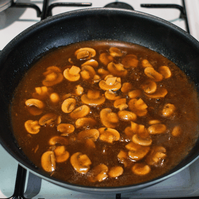 Pouring Marsala wine into skillet, simmering and scraping up browned bits.