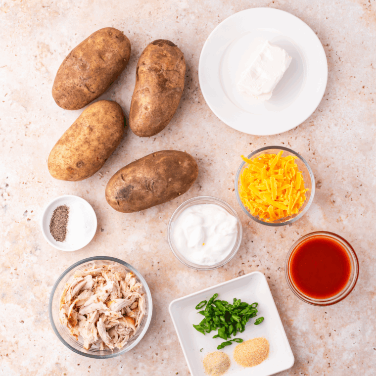 Ingredients needed for Air Fryer Twice Baked Buffalo Chicken Potatoes on kitchen table.