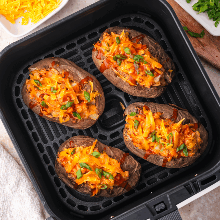Air Fryer Twice Baked Buffalo Chicken Potatoes stuffed with buffalo chicken, melted cheese, and crispy skin.