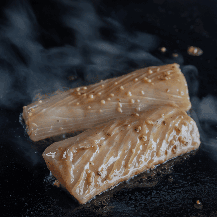 Grilling mahi mahi fillets on an oiled grill rack until cooked through.