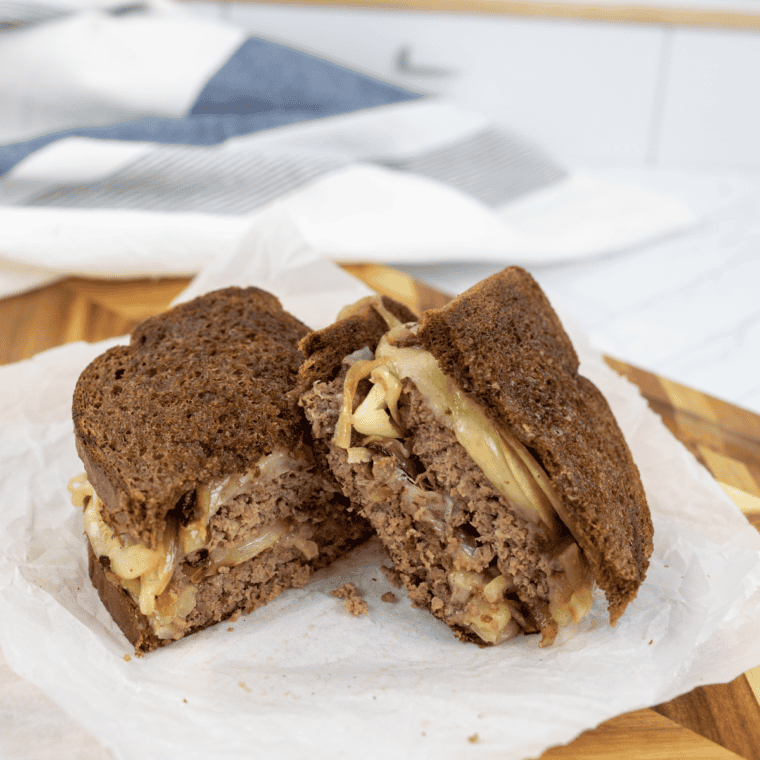 Blackstone Patty Melt with juicy beef, melted cheese, and crispy toasted bread.