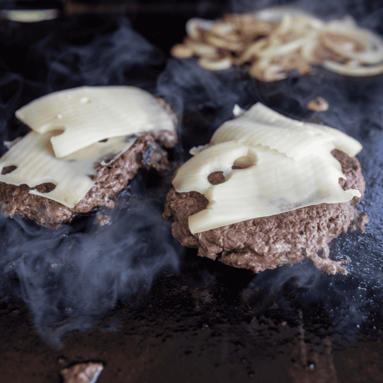 Blackstone Patty Melt with juicy beef patties, melted Swiss cheese, and crispy rye bread.