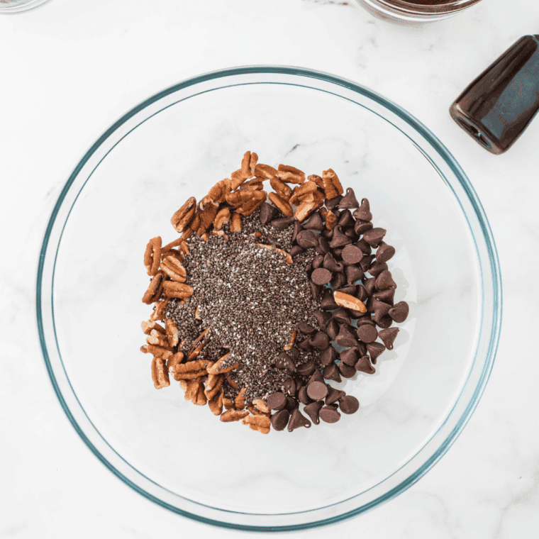 Mixing melted coconut oil, coconut sugar, almond butter, maple syrup, and vanilla extract in a large bowl.