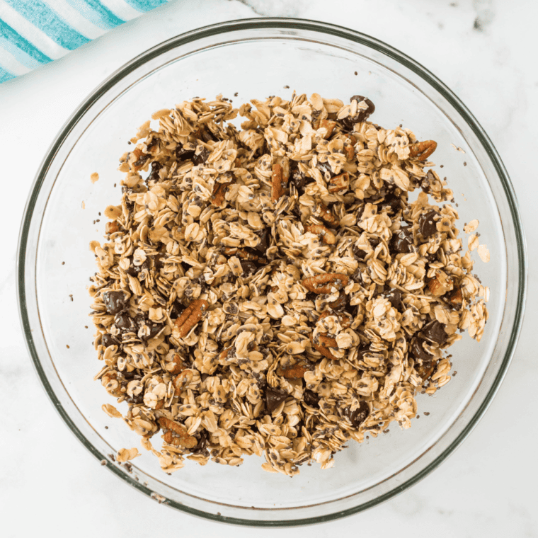 Adding rolled oats, oat flour, chia seeds, sea salt, cinnamon, and baking soda to the wet mixture and stirring to coat.