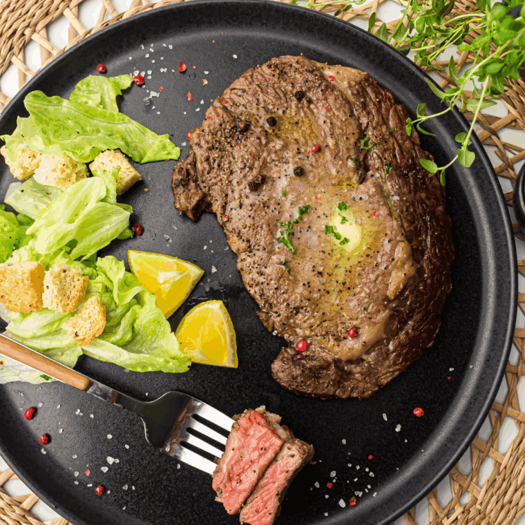 Copycat Applebee's Bourbon Street Steak served with sizzling onions and a rich bourbon glaze, perfect for a hearty dinner.