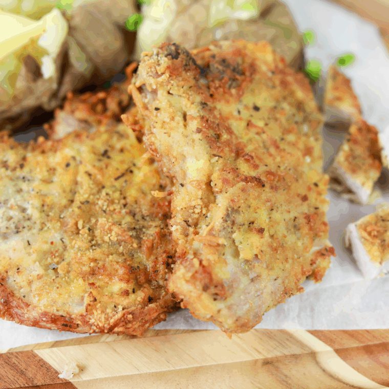 Cooked pork chops on plate.