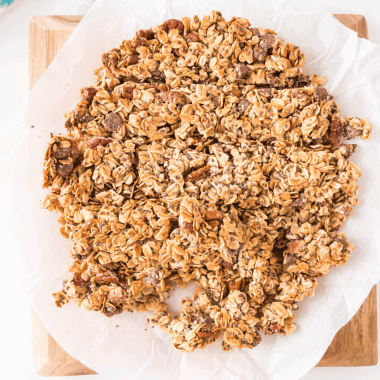 Transferring the granola mixture into a baking dish, pressing it down evenly, and baking until golden brown.