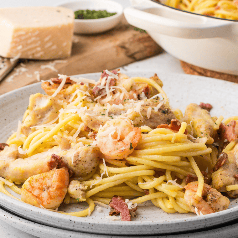 Serve pasta on plates, garnished with parsley and extra Parmesan, and enjoy while warm.