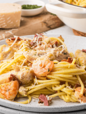 "Copycat Olive Garden Chicken and Shrimp Carbonara with creamy garlic Parmesan sauce and tender pasta."