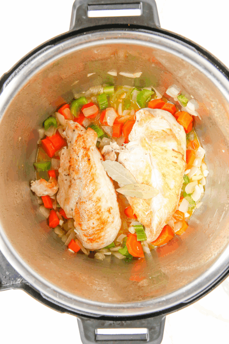 Adding chicken, potatoes, broth, thyme, salt, and pepper to the Instant Pot.