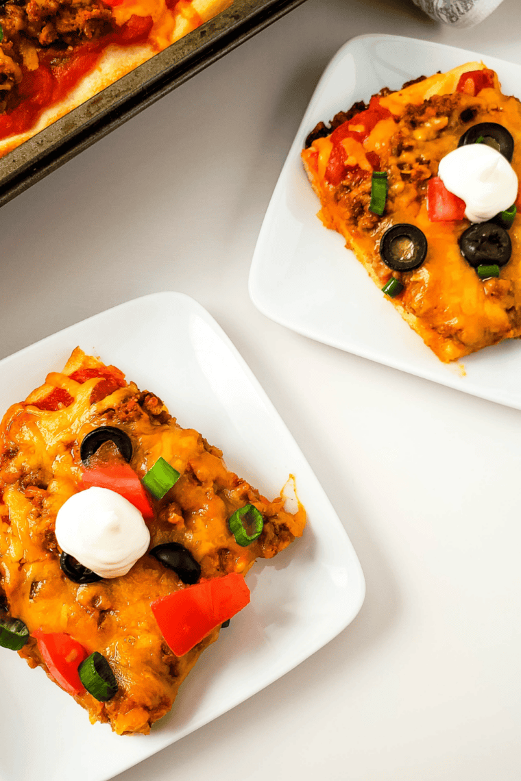 Homemade taco pizza for Taco Tuesday, made with refrigerated dough and finished with sour cream