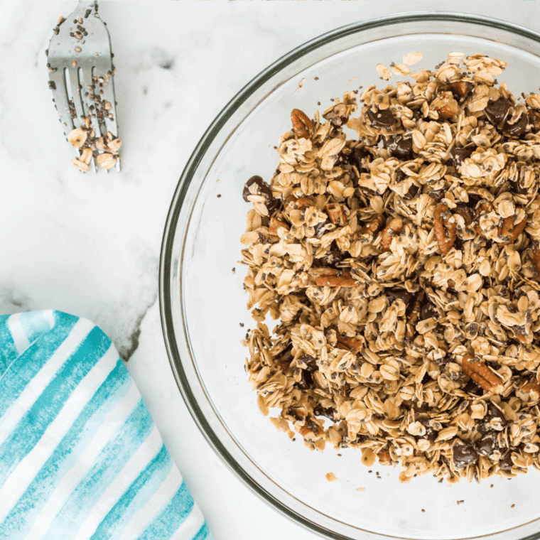 Mixing oats, cinnamon, salt, seeds, honey, olive oil, and vanilla extract in a large bowl.