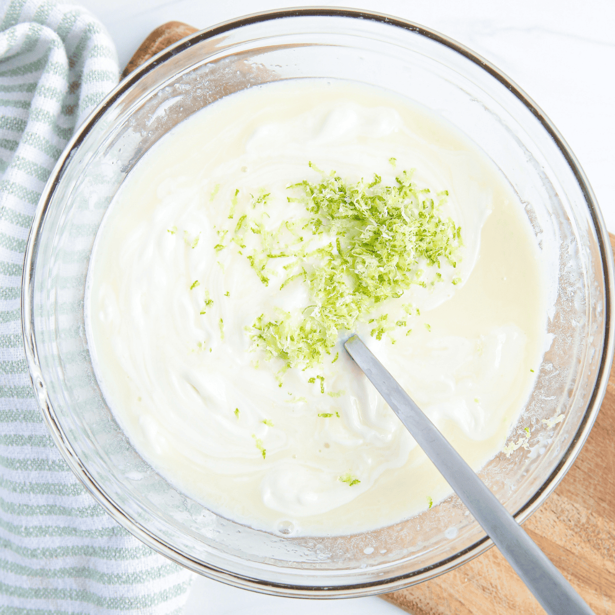 Homemade Key Lime Curd with fresh key limes, creamy texture, and tangy flavor.