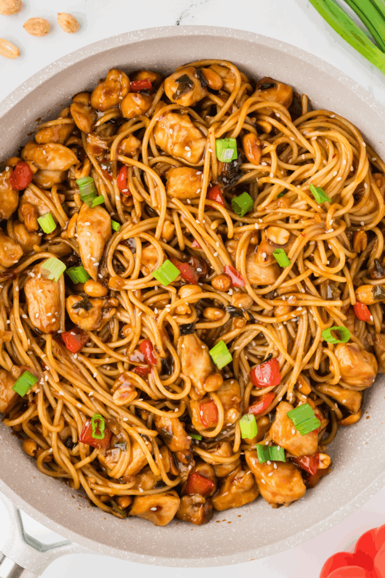A delicious plate of Kung Pao Chicken Spaghetti with tender chicken, vegetables, and a spicy sauce.