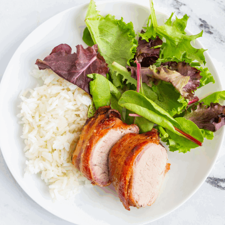 Ninja Air Fryer Bacon Wrapped Pork Tenderloin with crispy bacon and tender pork.