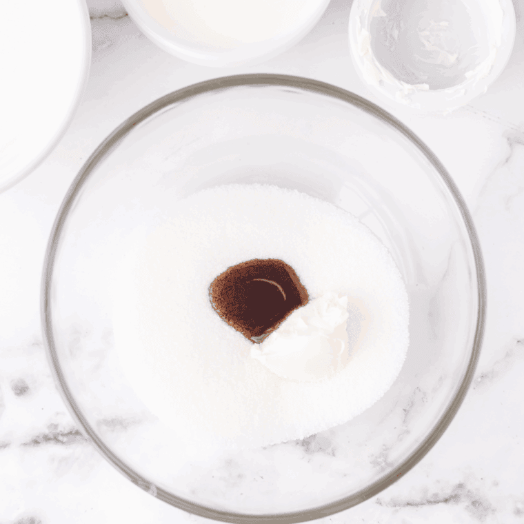 Mixing whole milk, heavy cream, sugar, vanilla, cinnamon, and salt in a bowl.