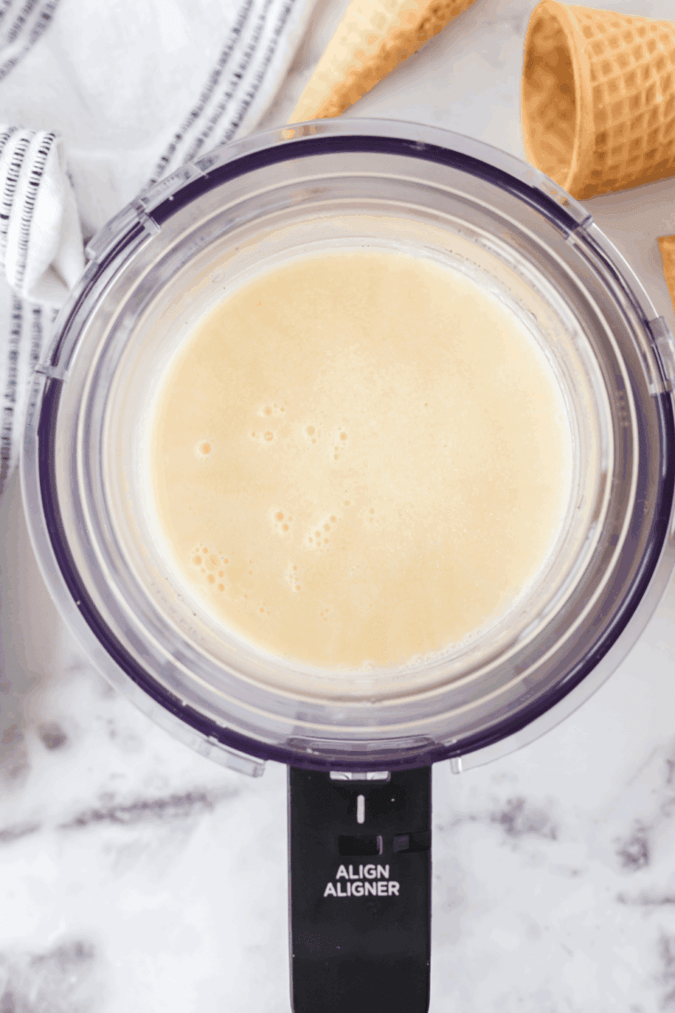 Pouring the mixture into a Ninja Creami pint and freezing for 24 hours.