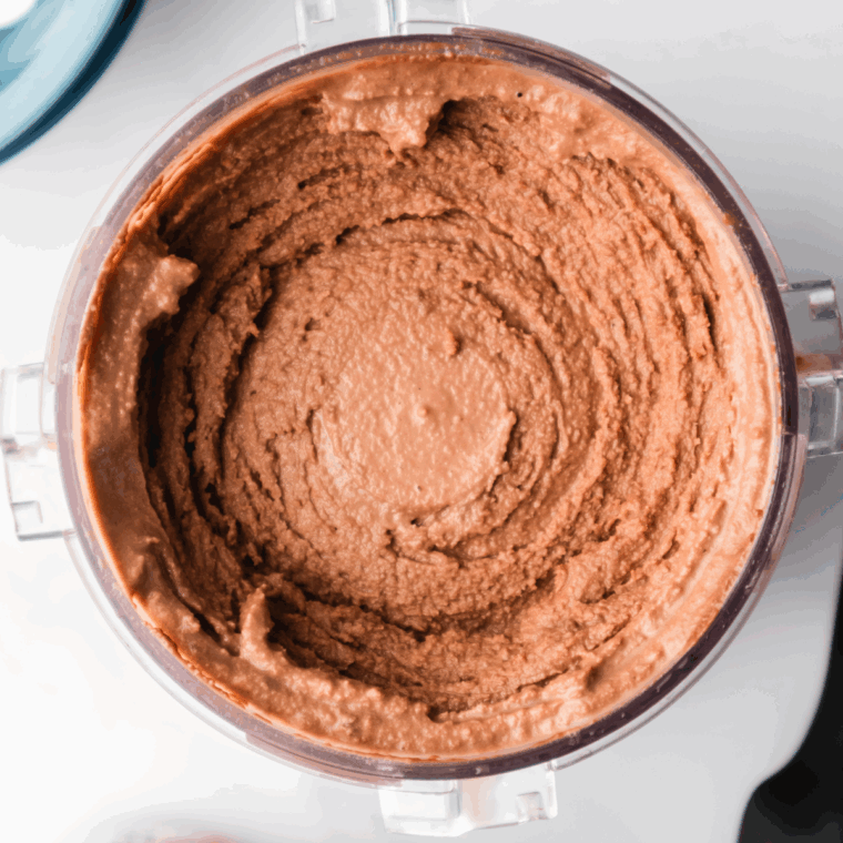 Scoops of Nutella gelato in a bowl, made with the Ninja Creami and topped with chocolate drizzle.