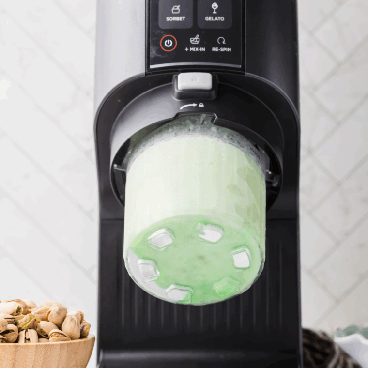 Removing frozen pint from the freezer, placing it in the Ninja Creami, and selecting the "Gelato" function to churn until smooth.