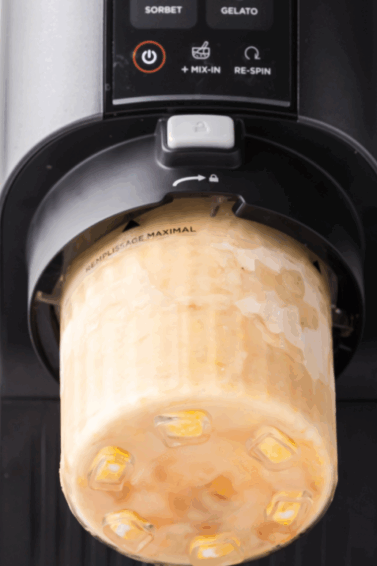 Placing the pint in the outer bowl, installing the Creamerizer™ Paddle, and locking the lid.