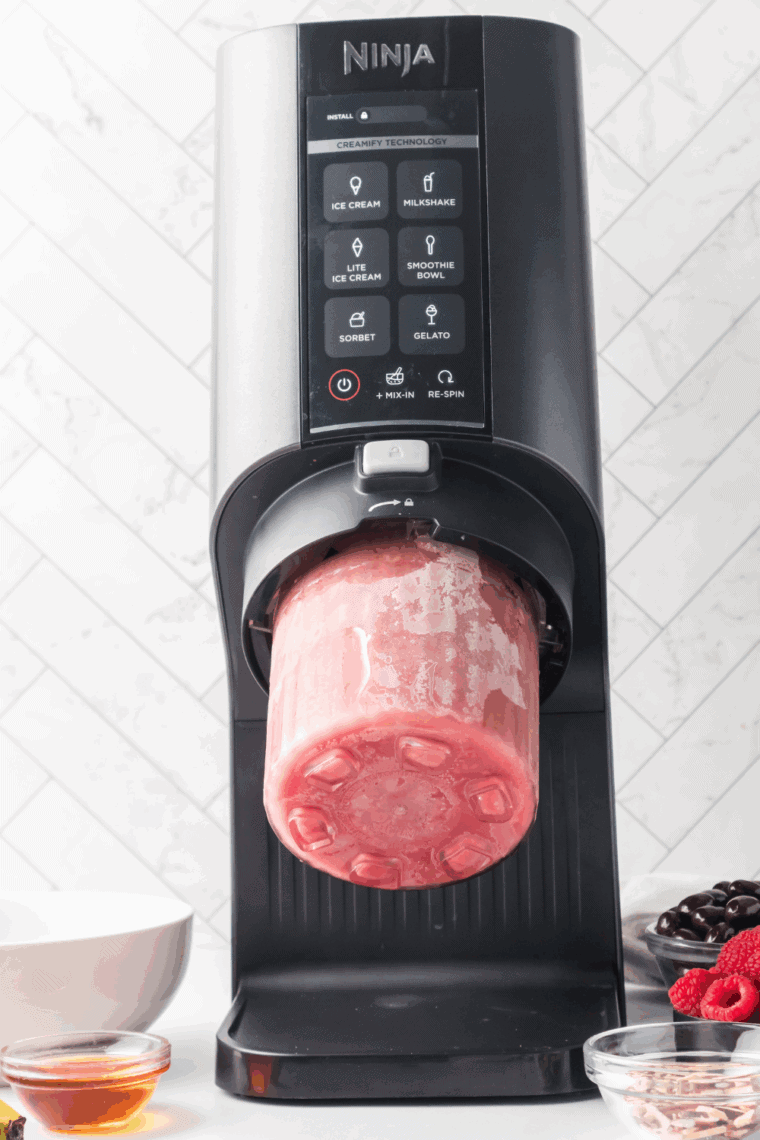 Processing the frozen mixture in the Ninja Creami using the Milkshake or Sorbet function.