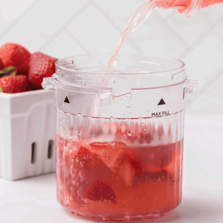 Cleaning and hulling strawberries, juicing the lemon, and measuring açai powder, maple syrup, and water for the refresher.