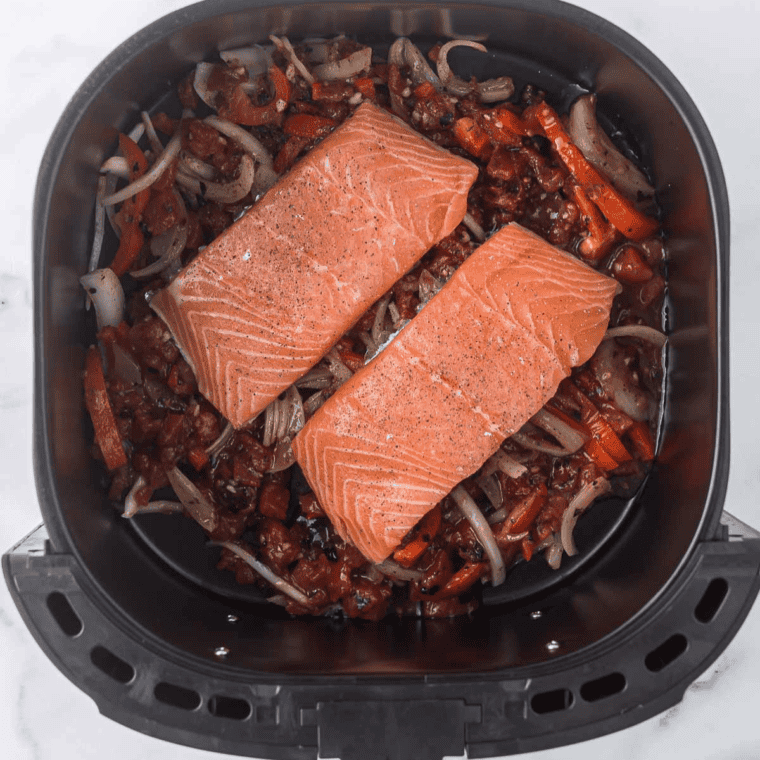 Place raw salmon in the air fryer basket.
