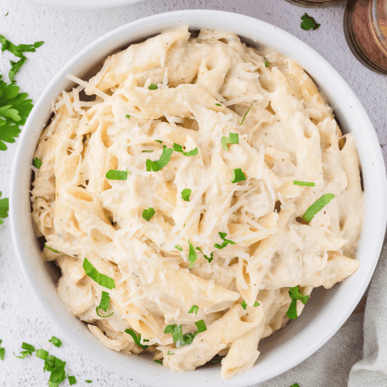 Slow Cooker Olive Garden Chicken Pasta with creamy Alfredo sauce and tender chicken.