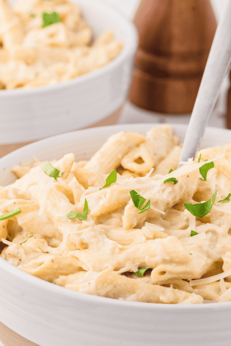 Slow Cooker Olive Garden Chicken Pasta with creamy Alfredo sauce and tender chicken.