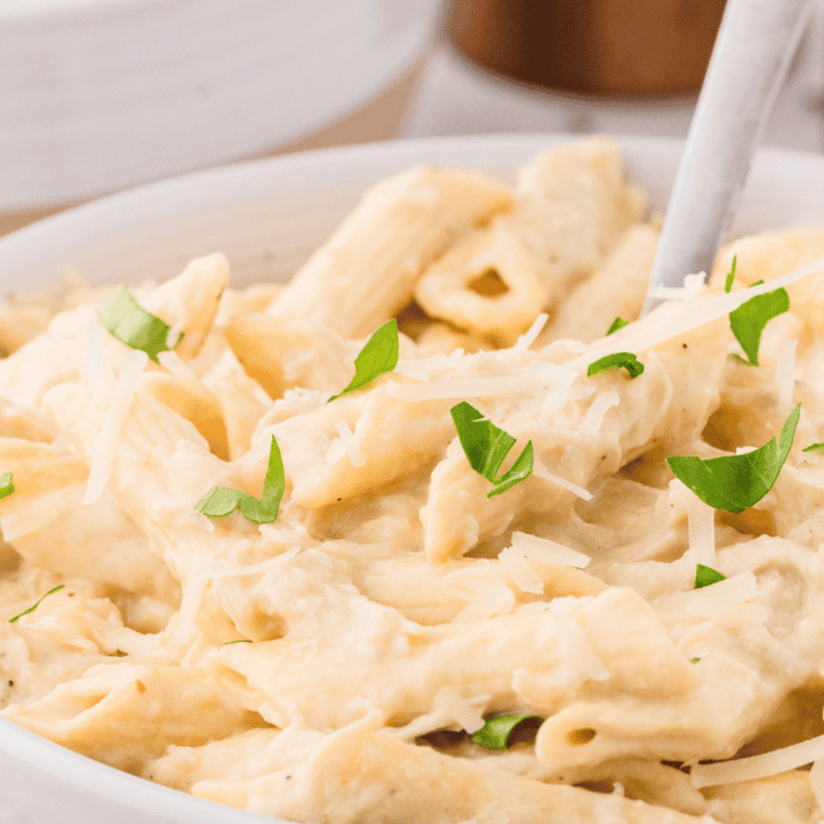 Slow Cooker Olive Garden Chicken Pasta with creamy Alfredo sauce and tender chicken.