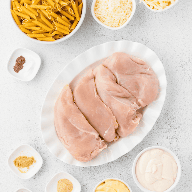 Ingredients needed for Slow Cooker Olive Garden Chicken Pasta on kitchen table.