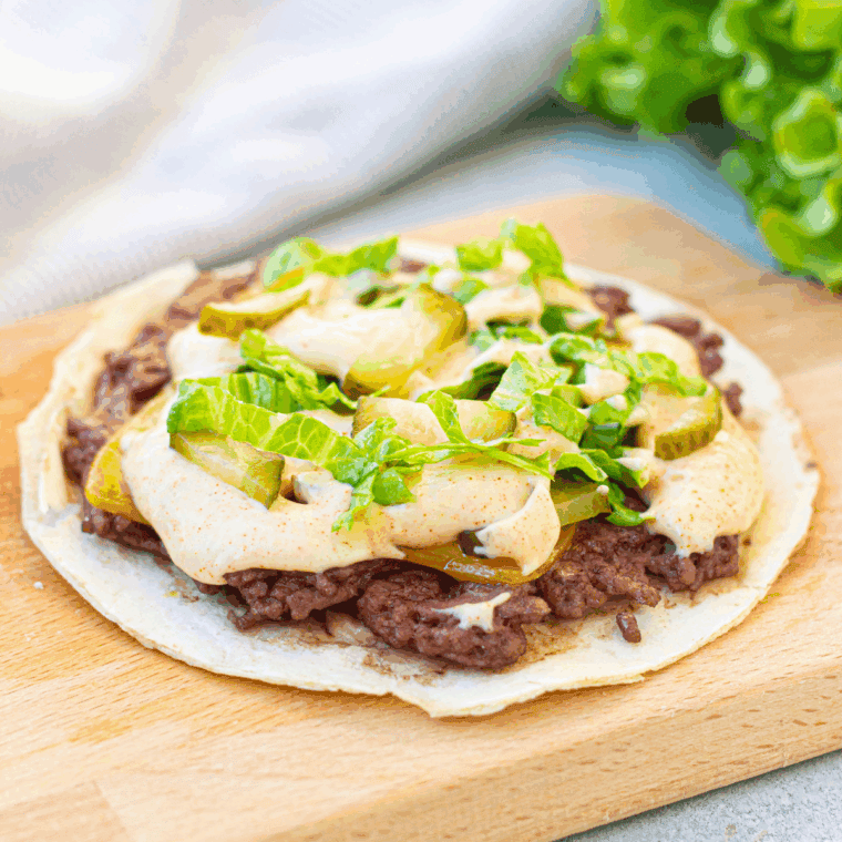 Air Fryer Big Mac Smash Tacos with crispy ground beef, cheese, pickled cucumbers, and a creamy sauce.