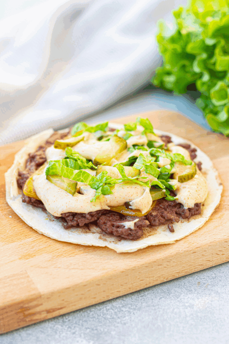 Air Fryer Big Mac Smash Tacos filled with crispy beef, cheese, pickled cucumbers, lettuce, and a creamy sauce, all cooked to perfection in the air fryer.