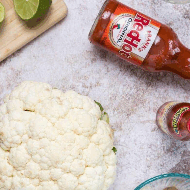 Ingredients required for air fryer cauliflower on kitchen table.
