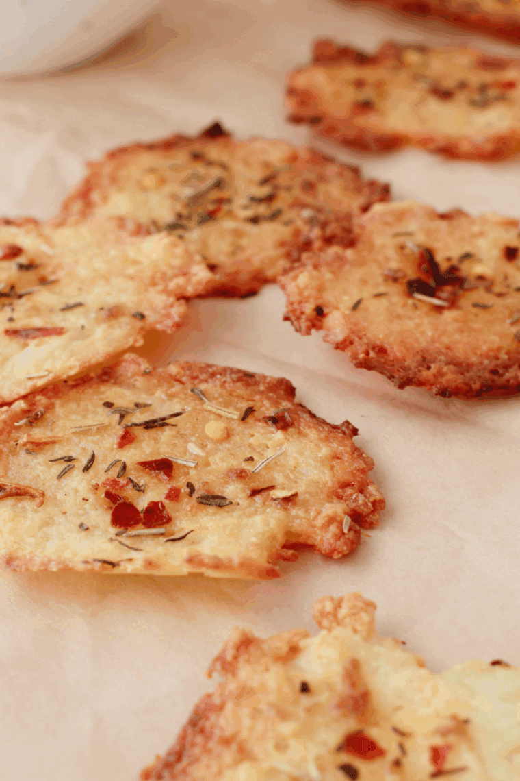 Golden, crispy Air Fryer Cottage Cheese Chips with a sprinkle of garlic powder, chili flakes, and Italian herbs.