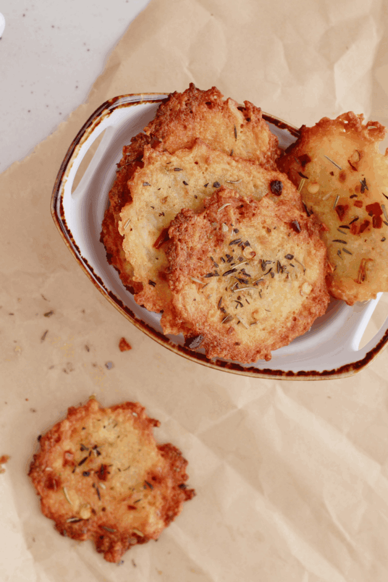 Golden and crispy Air Fryer Cottage Cheese Chips seasoned with garlic, chili flakes, and Italian herbs.