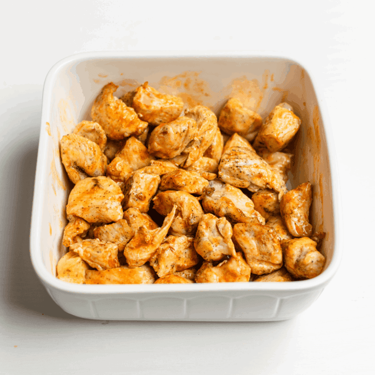 Coated chicken bites with buffalo sauce.